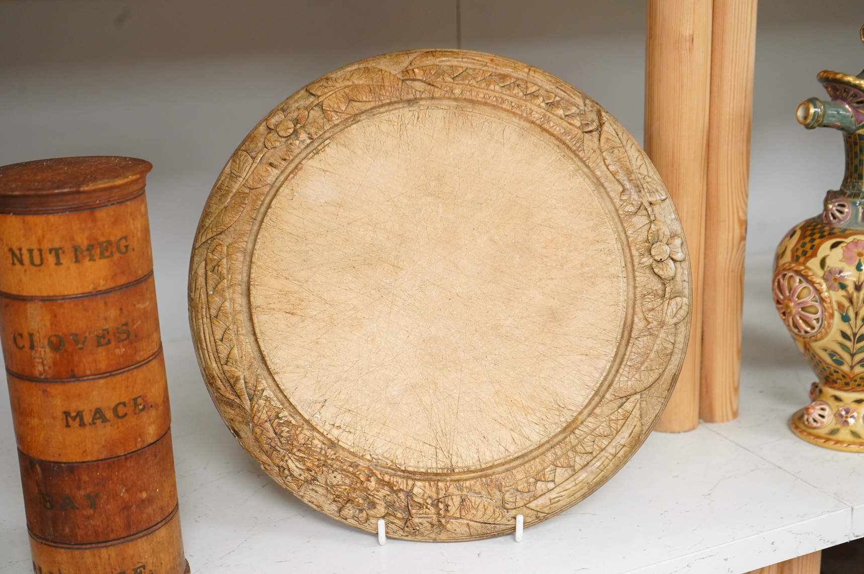 A Victorian treen spice tower and a carved bread board, 30cm in diameter